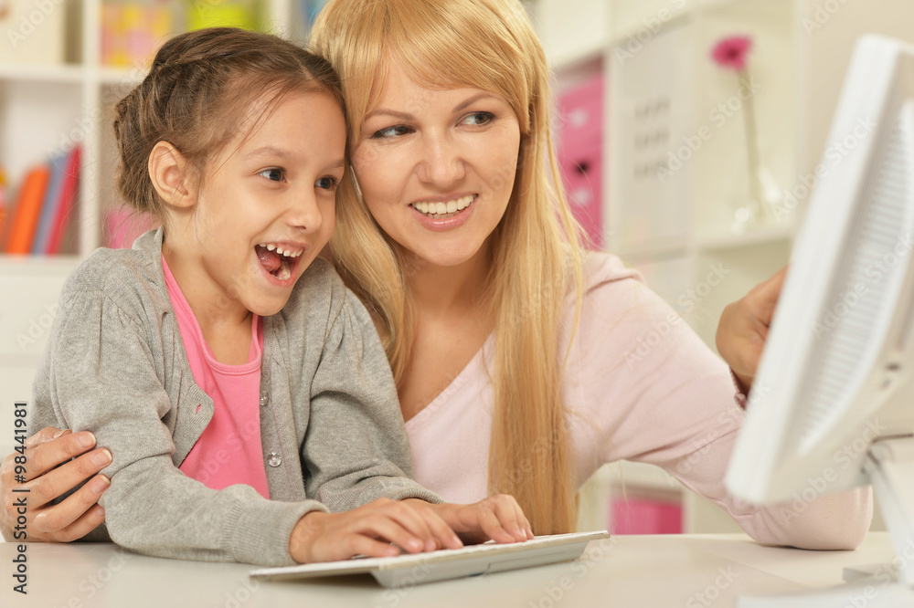 girl playing with mother on computer girl playing with mother on computer