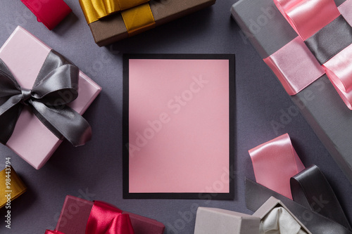 Layout stylish card with place for the text and a lot of colorful gifts on a gray background