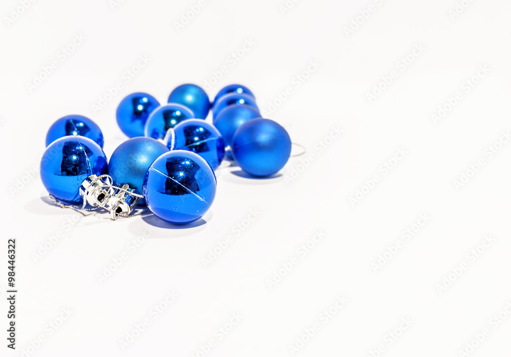 Fototapeta premium Lot of blue small decorative christmas balls on white