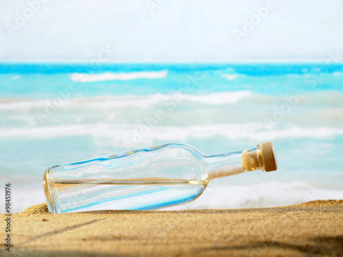  bottle with water on the sea sand