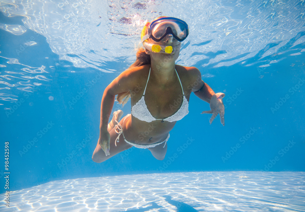 I eat breakfast Pollinate Setting Girl in bikini swimming underwater in blue pool Stock Photo | Adobe Stock