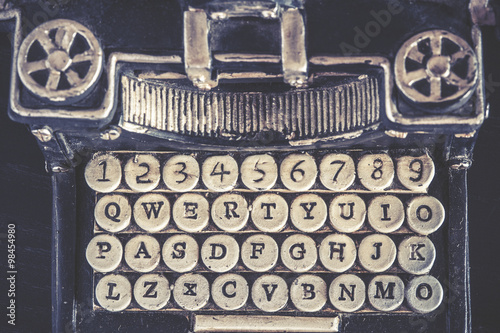 Vintage typewriter detail with stone carved keys photographed with shallow depth of field