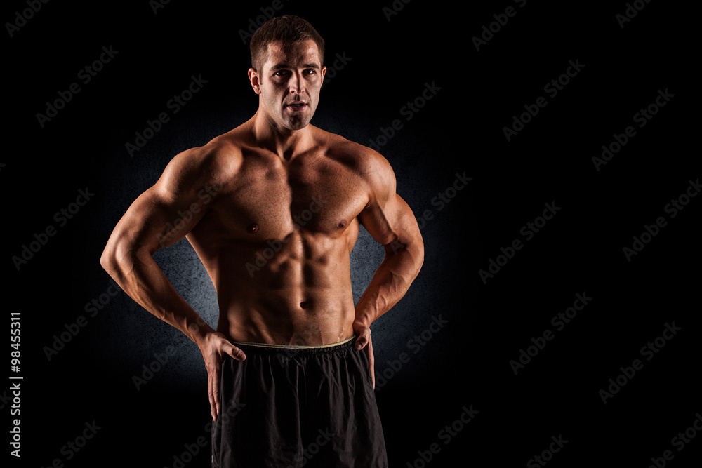 Fototapeta premium Closeup of a muscular young man lifting weights