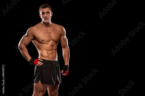 a young and fit male model posing his muscles