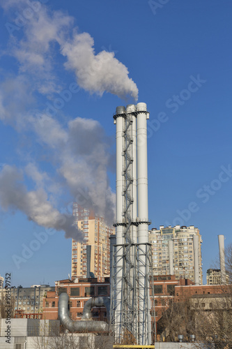 Thermal power plant with a smoke against city landscape