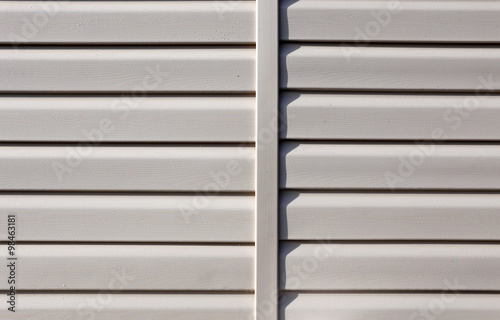 Installation on facade of the house panels beige vinyl siding