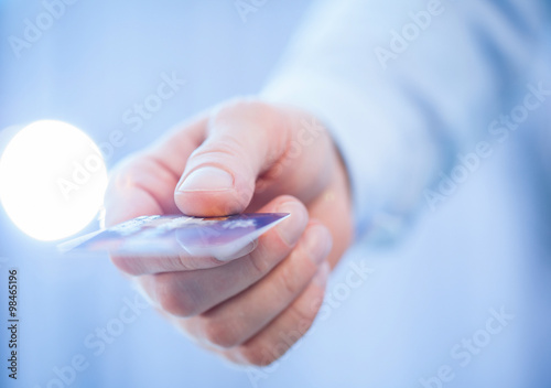 Businessman s hand giving credit card to you