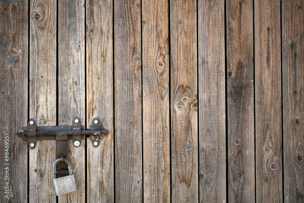 Old wooden gate with padlock