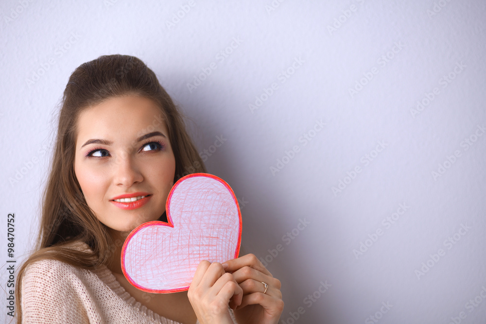 Portrait of young beautiful woman showing gift card. Valentines Day Portrait of young beautiful woman showing gift card. Valentines Day