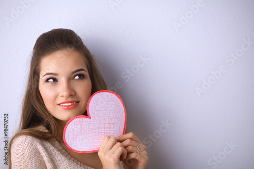 Portrait of young beautiful woman showing gift card. Valentines Day