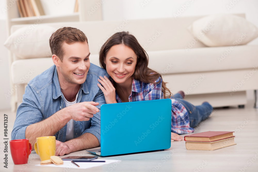 Attractive married couple is using notebook at home Attractive married couple is using notebook at home