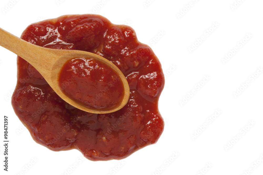 Ketchup in wooden spoon isolated on white Ketchup in wooden spoon isolated on white