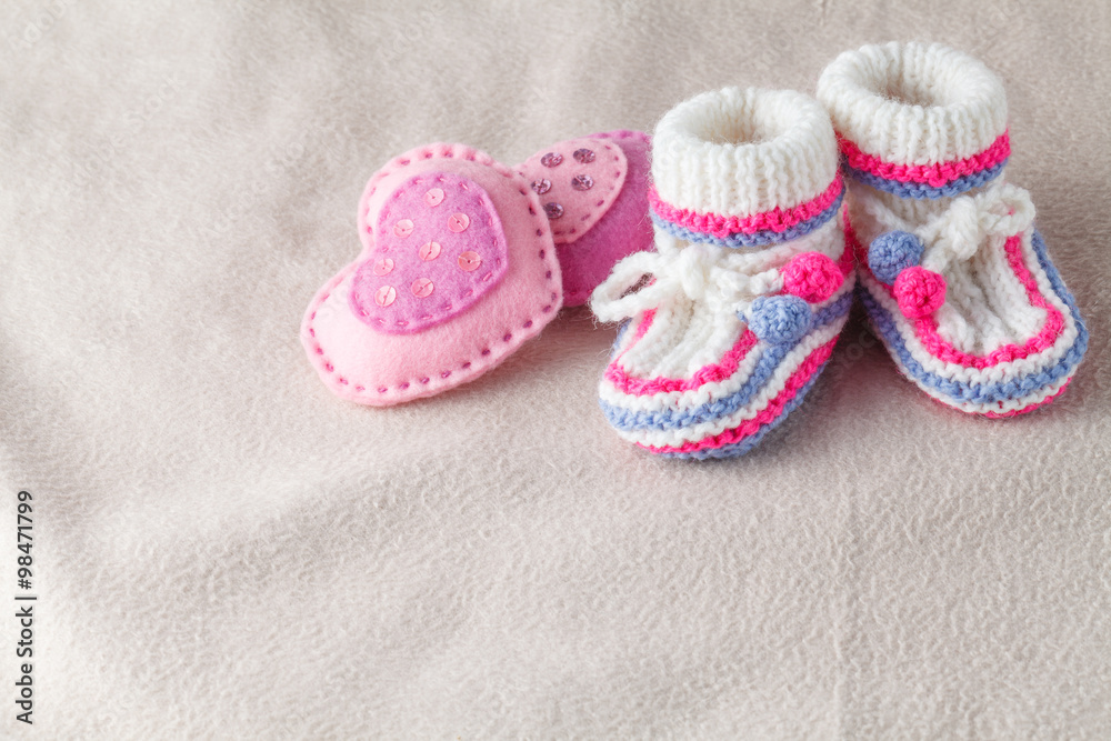 child booties on soft felt backgound child booties on soft felt backgound