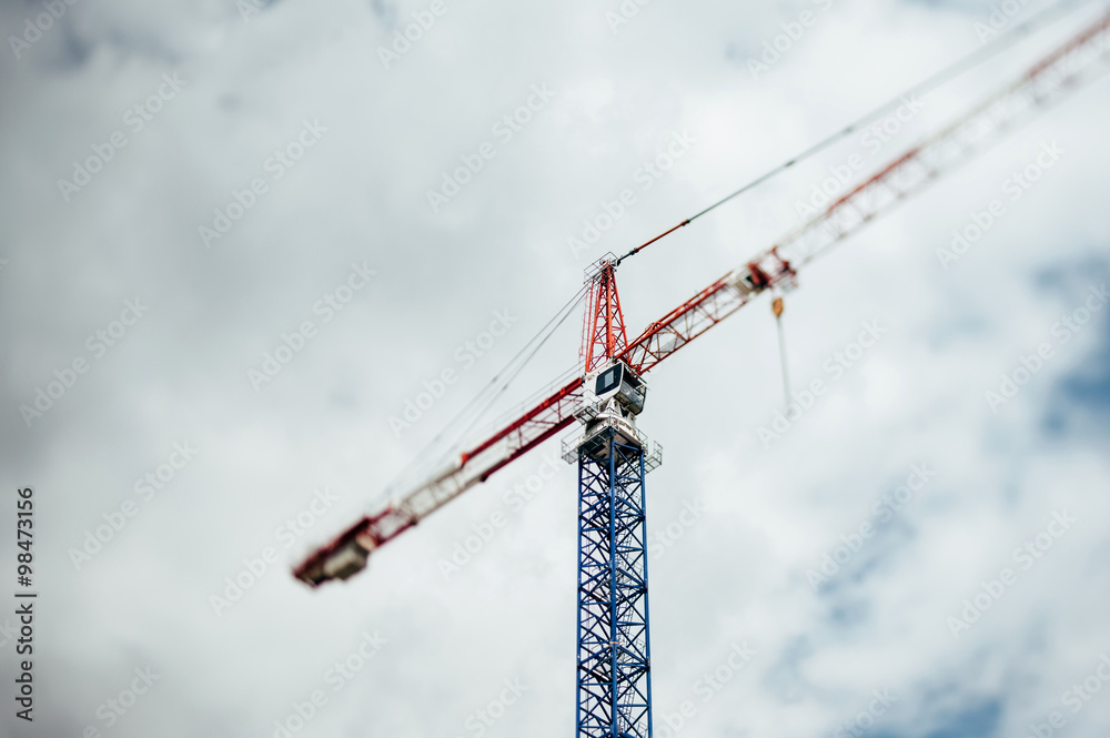 Tilt-shift defocused view of a crane against dark sky Tilt-shift defocused view of a crane against dark sky