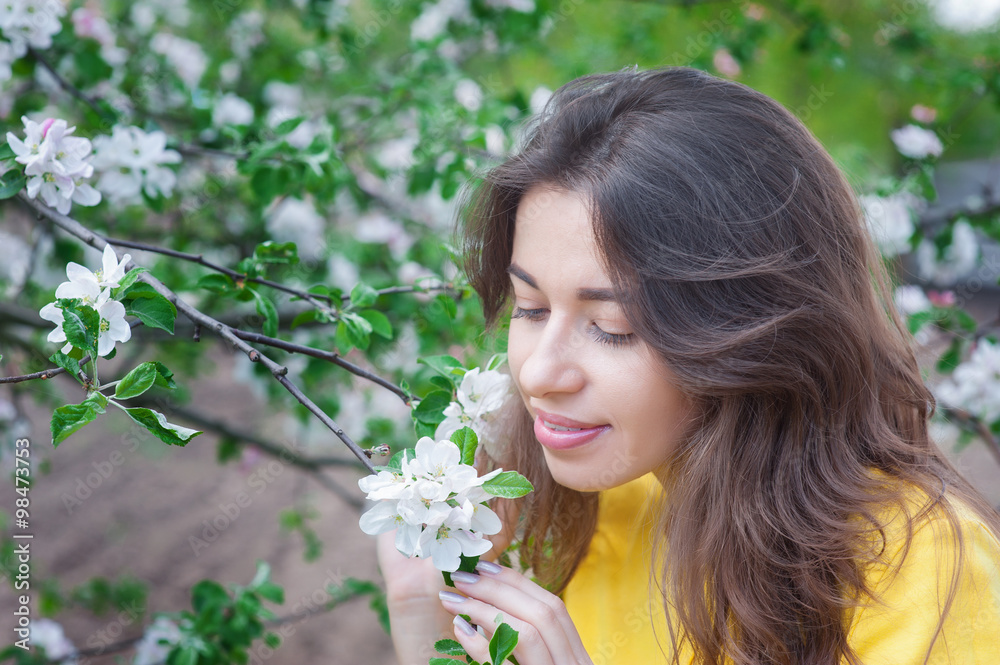 beautiful woman near blossoming tree in spring beautiful woman near blossoming tree in spring