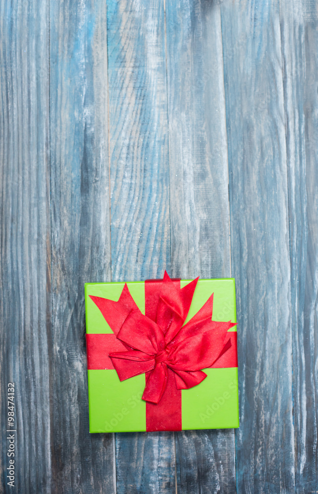 Fototapeta premium Christmas Present wrapped in paper on a wooden background for a