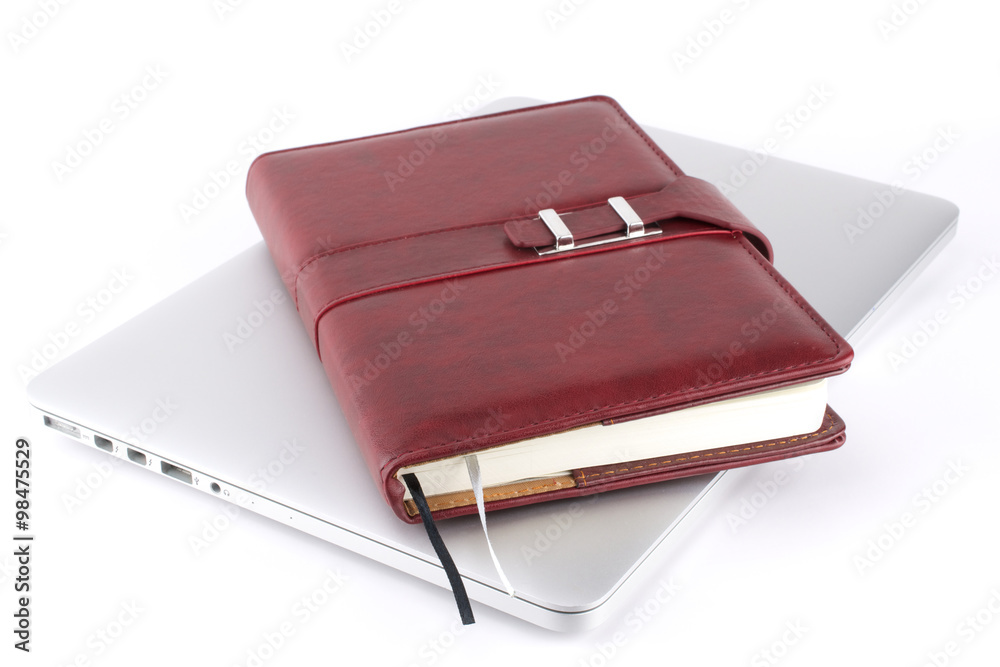 Brown leather notebook on a laptop. White background
Brown leather notebook on a laptop. White background