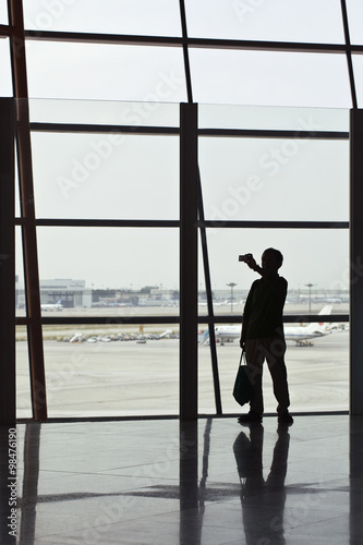 Man takes a photo on Beijing Capital Airport