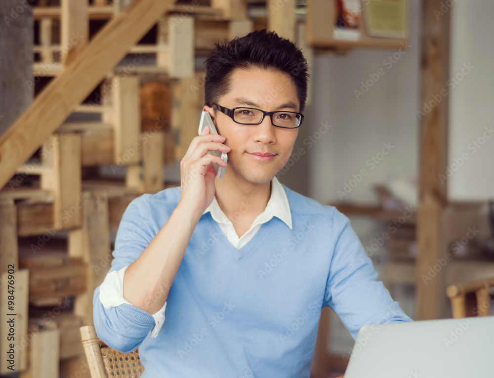 Fototapeta premium Portrait of young businessman with mobile