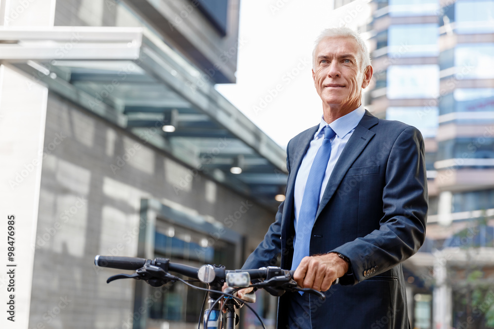 Successful businessman riding bicycle Successful businessman riding bicycle