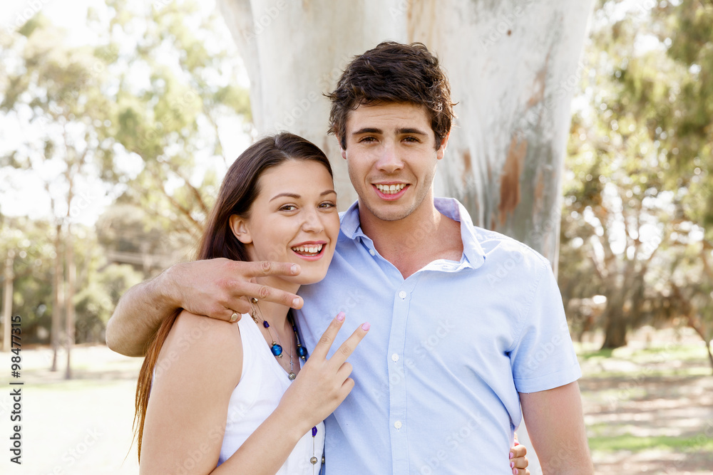 Young couple in the park celebrating Young couple in the park celebrating