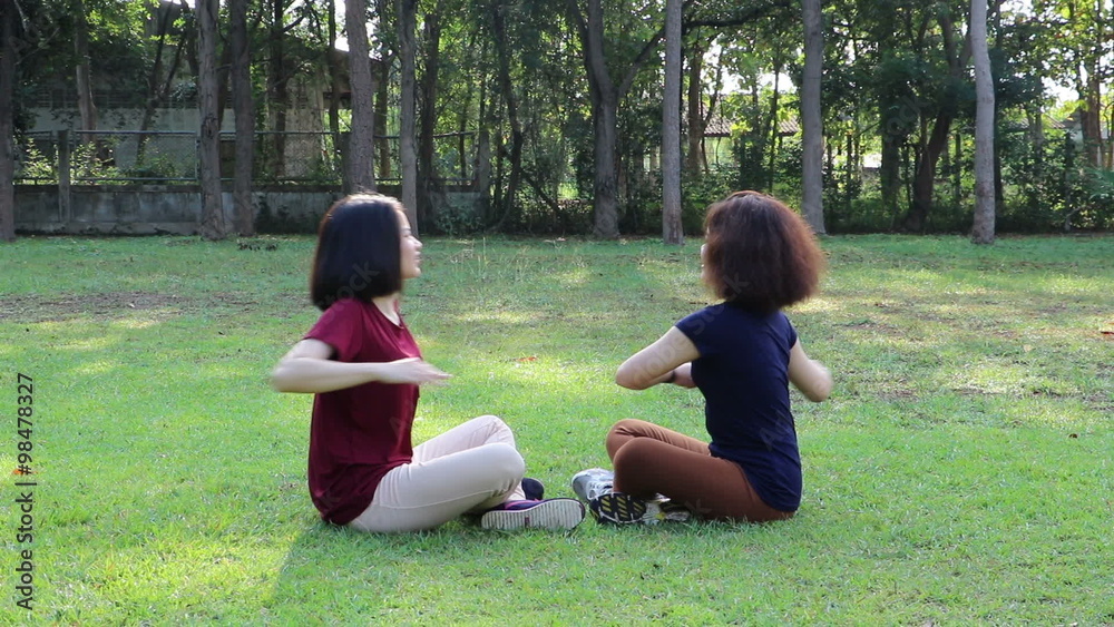 Young Asian girls doing exercise in park Young Asian girls doing exercise in park