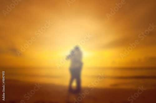 blurred of couple kissing on the beach
