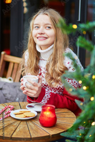 Beautiful young girl in an outdoor Parisian cafe