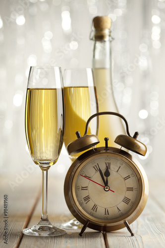 Happy new year - glasses of champagne and alarm clock