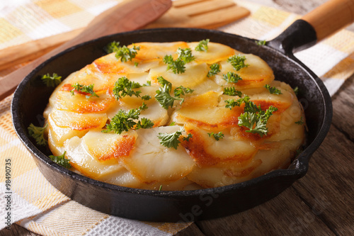 Homemade baked potatoes in a pan close-up. horizontal
