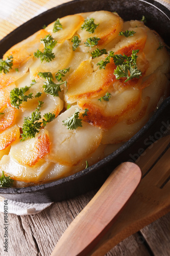 Wallpaper Mural Delicious potato casserole in a pan close-up. vertical 
 Torontodigital.ca
