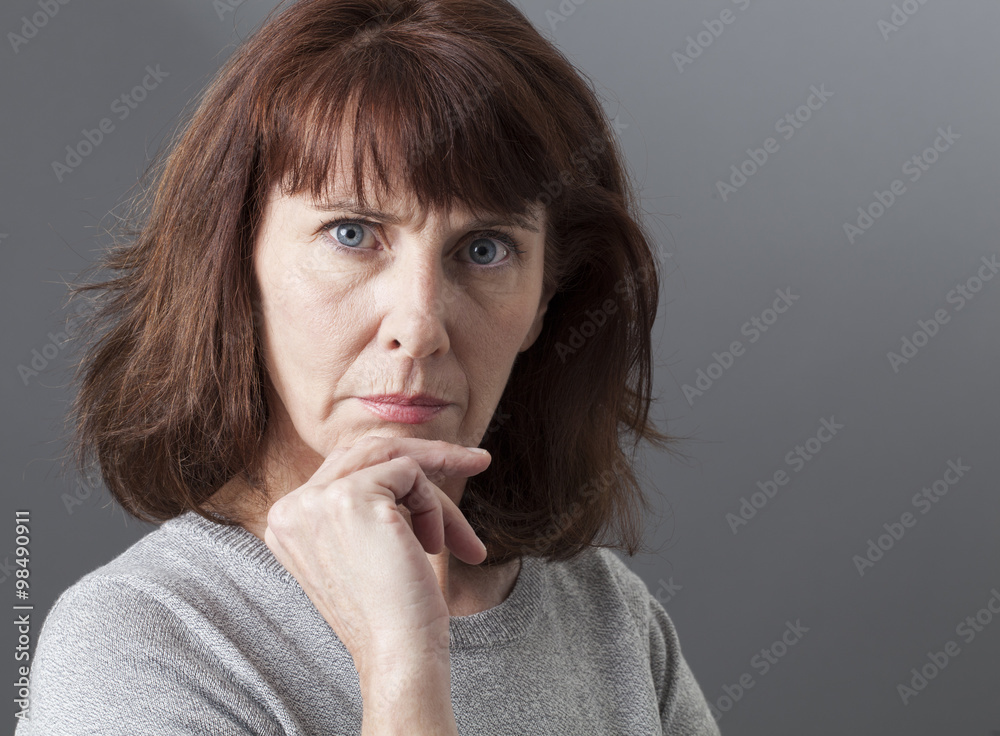 pride and arrogance - displeased mature woman complaining, expressing her disagreement and irritation,gray background in studio pride and arrogance - displeased mature woman complaining, expressing her disagreement and irritation,gray background in studio