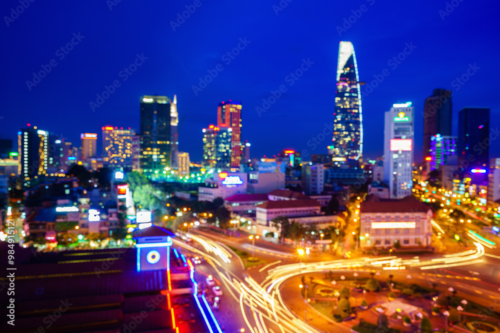 Saigon downtown and Ben Thanh Market with defocused bokeh lights as abstract background, Vietnam. Saigon is the largest city and economic center in Vietnam with population around 10 million people.