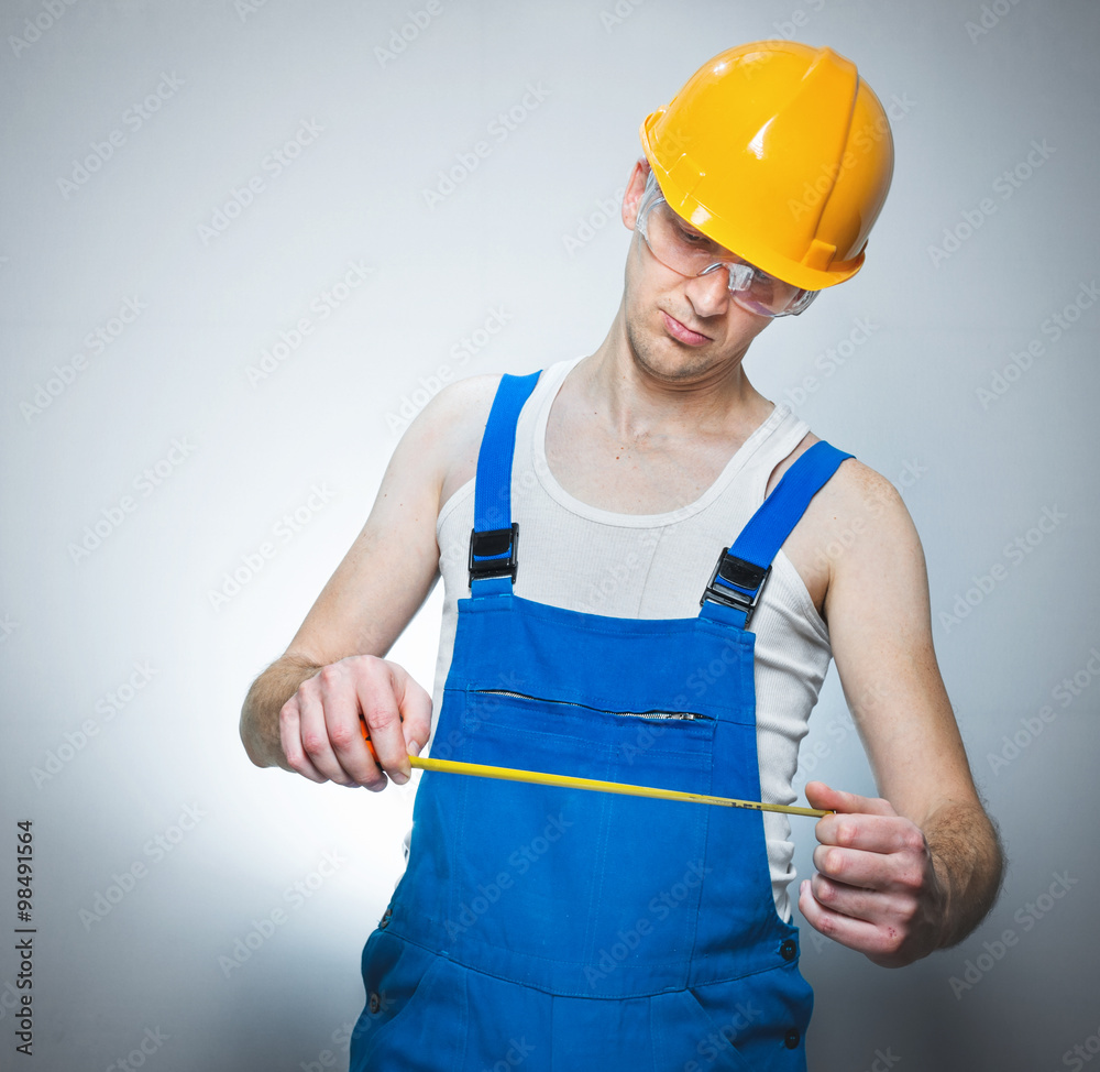 Young builder with meter Young builder with meter