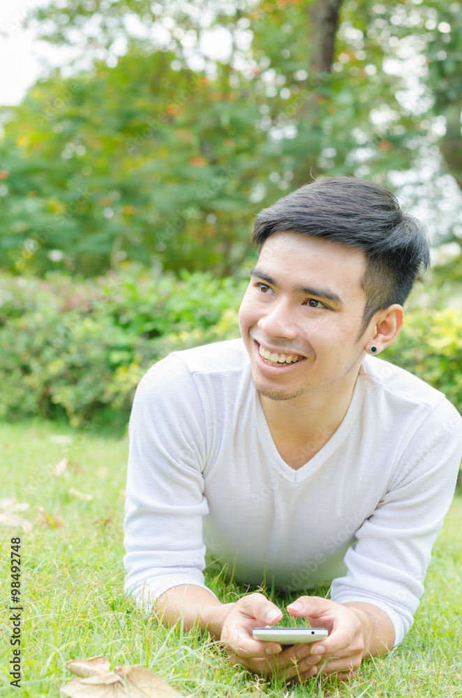 Young man communicate on social networks with mobile phone in pa Young man communicate on social networks with mobile phone in pa