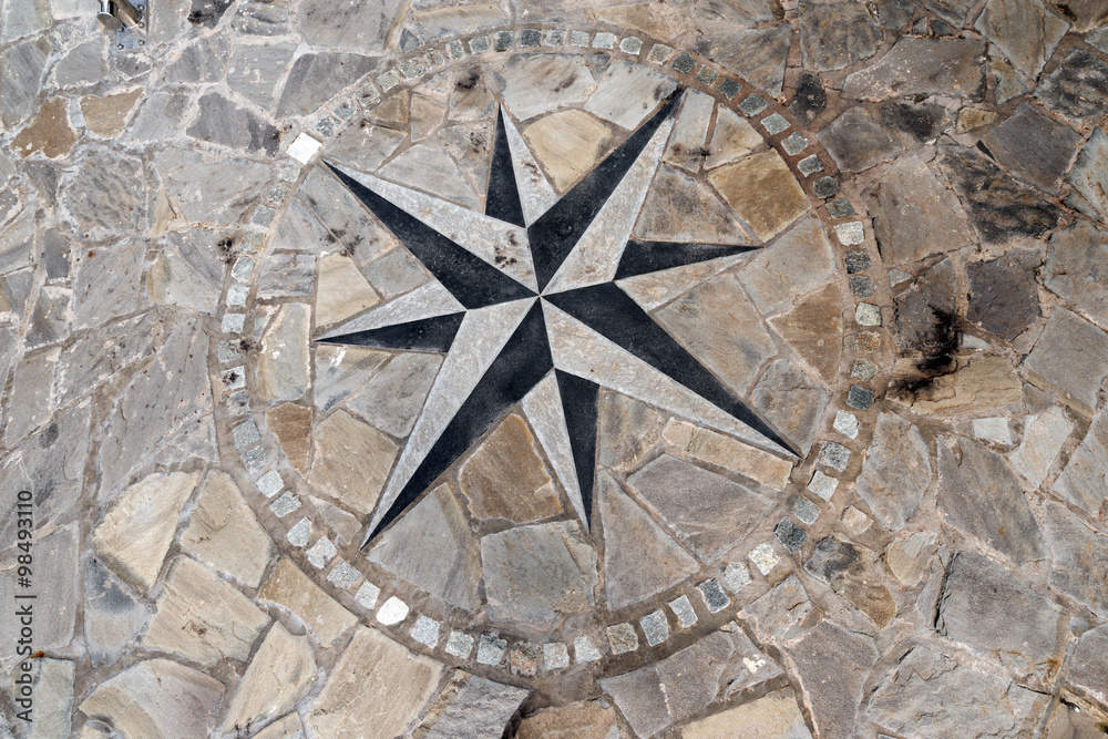Pavement Stone with Compass Rose / Stone flooring with compass rose 8 directions. A pier in Liguria harbor, italy