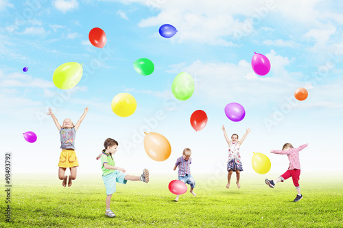 Playful children catch balloons