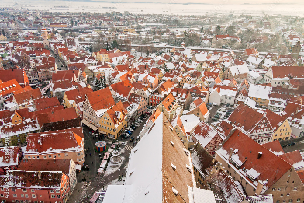 Winter panorama of medieval town within fortified wall. Top view from 