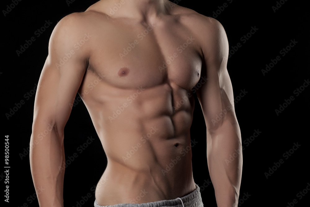 Muscular male torso on a black background