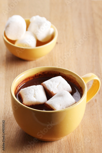 hot chocolate drink in yellow cup and marshmallows