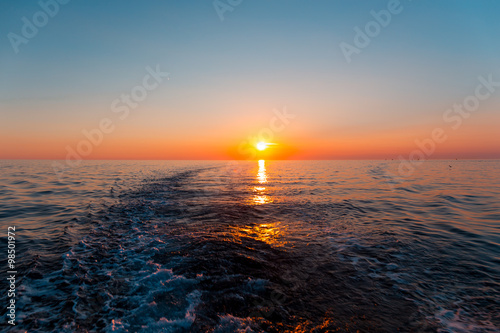 Sea sunset with ship trace