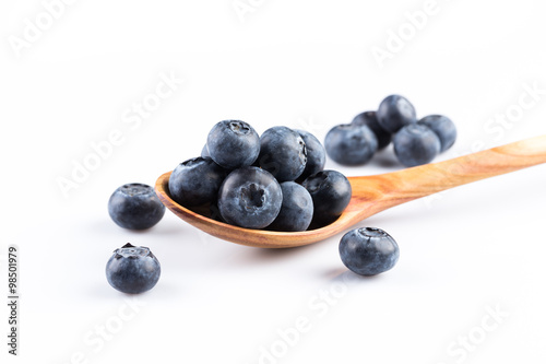 Fresh blueberries in wooden spoon