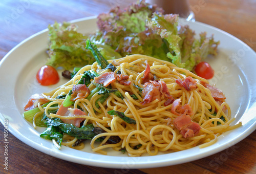 spaghetti with bacon on white plate