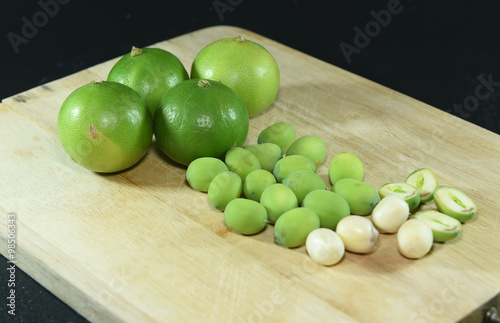 Lotus Seed and lemon on wooden block on black background photo