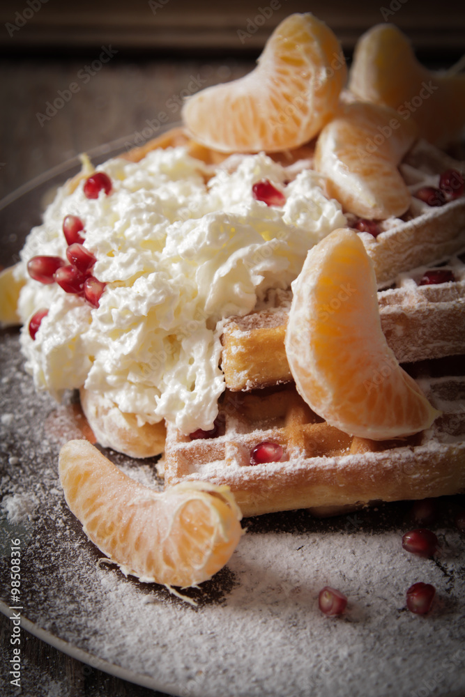 Square Belgian waffles with a tangerine and pomegranate and spri