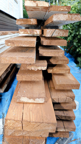 Unplaned thick planks covered with antiseptic preparation photo