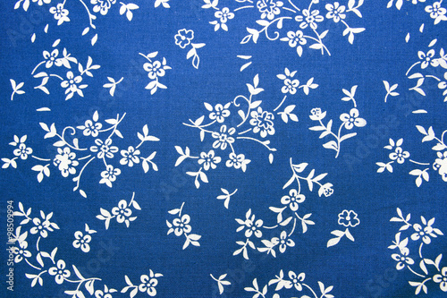 Closeup of blue cotton fabric with flowers.