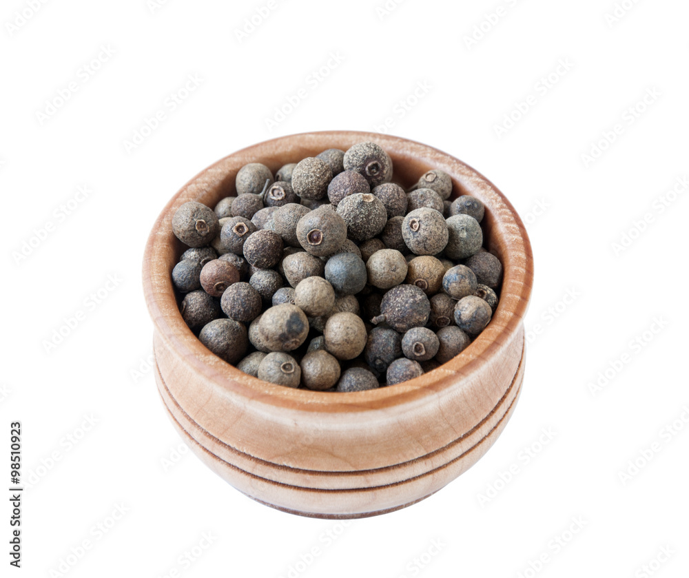 Black pepper in wooden bowl on the white background, top view