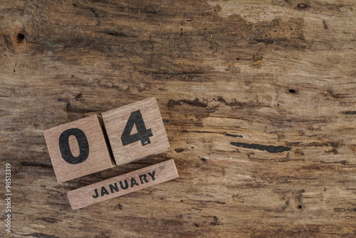 wooden cube calendar for january on wooden surface with copy space