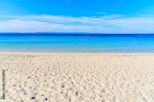 White sand beach with crystal clear azure sea water in Grande Sperone bay, Corsica island, France
